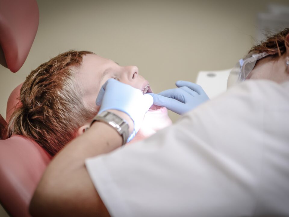 child with mouth open at dentist