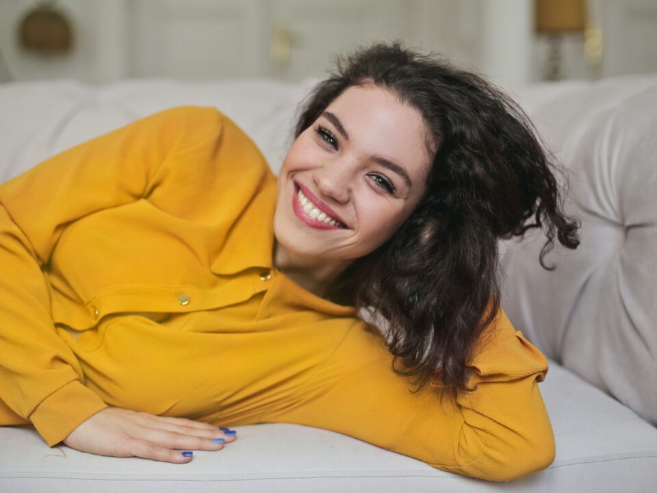 woman lying on sofa smiling