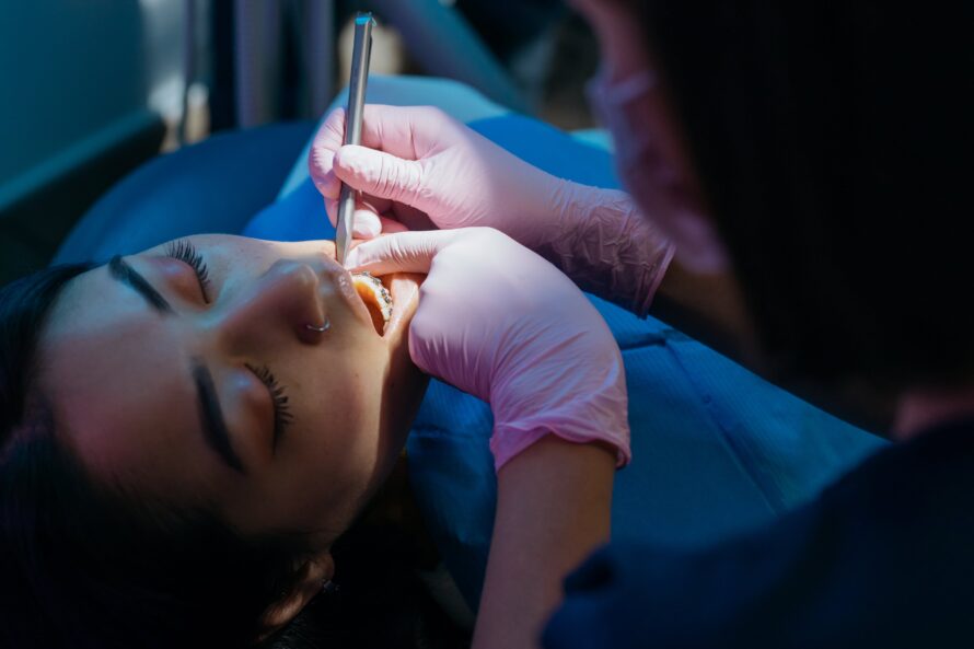 Close-up Photo of Dentist Examining Patient's Teeth for Root Canal Treatment